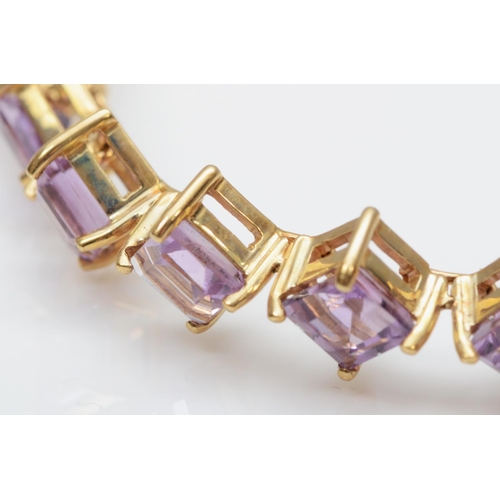 120 - A 9ct gold and amethyst line bracelet, stamped 375, claw set with square cut stones, 19.5cm, 14gm