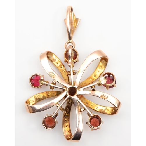 122 - An Edwardian 9ct rose gold garnet and half pearl openwork pendant, one stone a paste, stamped F.G. 9... 