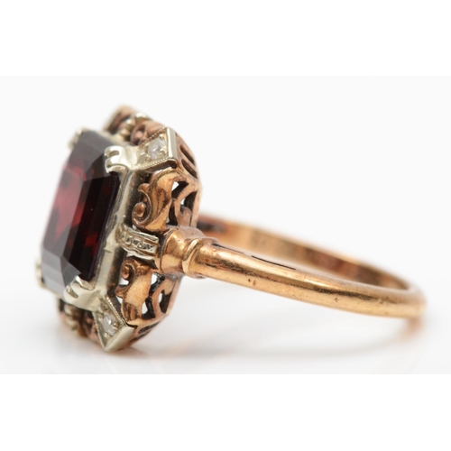 160 - A 9ct gold garnet panel ring, the claws set with diamonds, 14 x 14 mm overall, L 1/2, 4gm