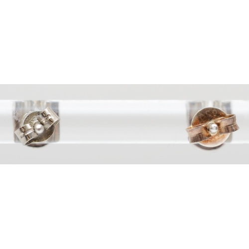 167 - A pair of white gold and diamond set ear studs, tests as 18ct gold collet set with brilliant cut sto... 