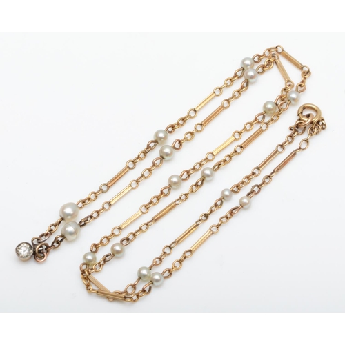 175 - An unmarked vintage rose gold and pearl necklace with an old cut brilliant drop below, 28cm,5.8gm