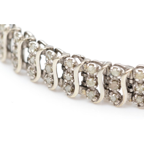 176 - A 9ct white gold and diamond line bracelet, claw set with rows of three stones, stated weight 2.00ct... 