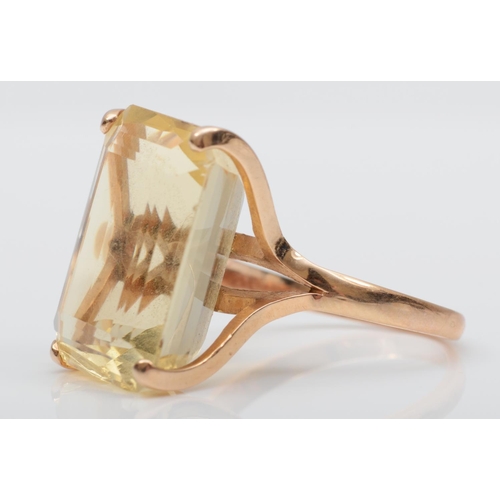 177 - A rose gold and citrine dress ring, tests as 14K gold, claw set with a step cut stone, 21 x 16mm, S ... 