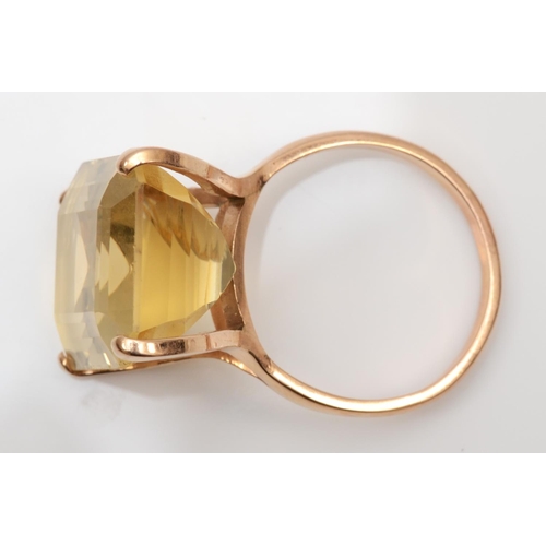 177 - A rose gold and citrine dress ring, tests as 14K gold, claw set with a step cut stone, 21 x 16mm, S ... 