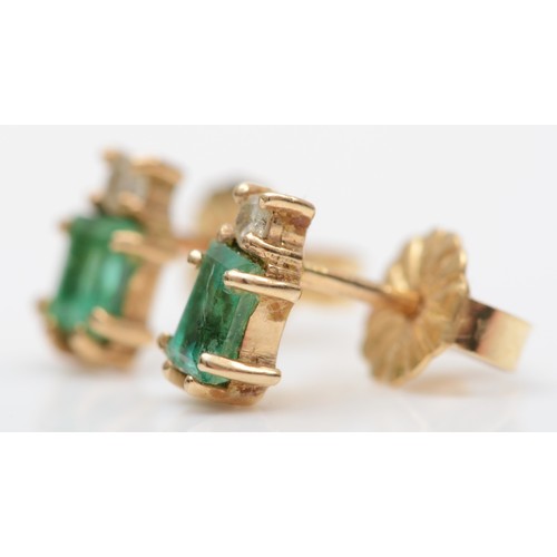 148 - A pair of gold emerald and diamond earstuds, the emerald cut stone with a brilliant above, 1gm