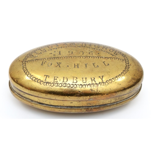 223 - An Edwardian Welsh brass oval tobacco box, by L. Morgan, Maker, Abercwmboi, S.W., the hinged lid eng... 