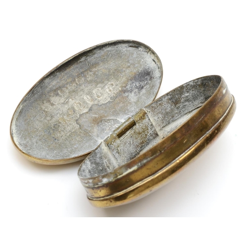 223 - An Edwardian Welsh brass oval tobacco box, by L. Morgan, Maker, Abercwmboi, S.W., the hinged lid eng... 