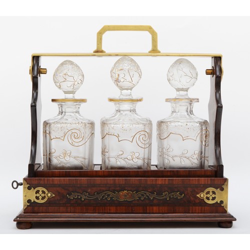 226 - A 19th century French burr walnut and rosewood three bottle tantalus, stamped D.P. DEPOSE, the frame... 