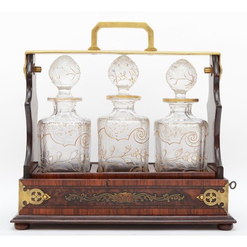 226 - A 19th century French burr walnut and rosewood three bottle tantalus, stamped D.P. DEPOSE, the frame... 