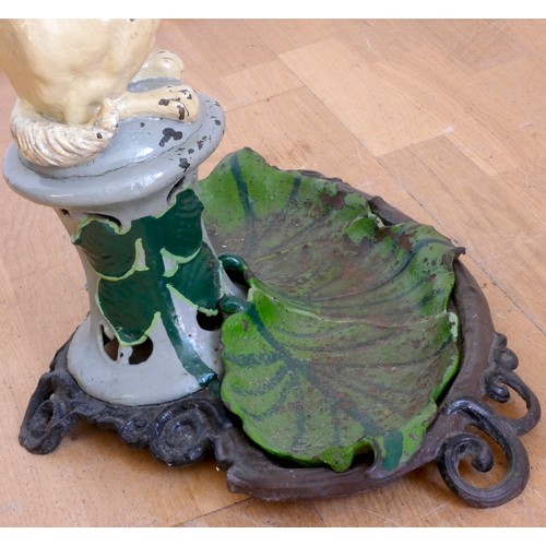 228 - A Victorian painted cast-iron umbrella stand
by Coalbrookdale, mid 19th century, modeled as a beggin... 