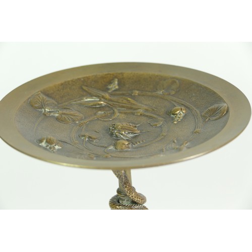 233 - A bronze tazza, the tripod base of sphinxes with climbing snake on a central baluster upright, raise... 