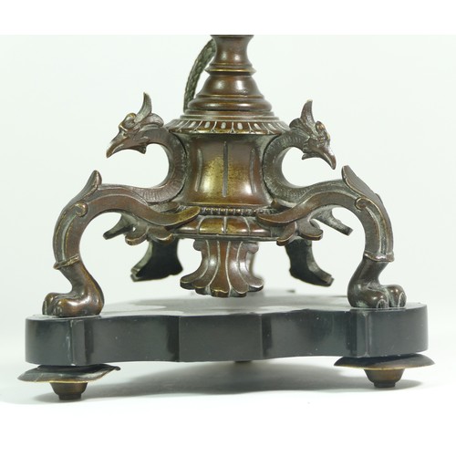 233 - A bronze tazza, the tripod base of sphinxes with climbing snake on a central baluster upright, raise... 