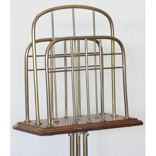 236 - An Edwardian rotating magazine rack, the brass tripod base with mahogany and with three brass divide... 