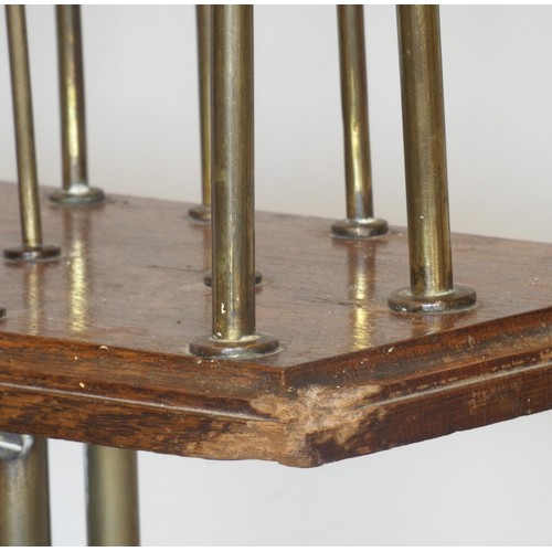 236 - An Edwardian rotating magazine rack, the brass tripod base with mahogany and with three brass divide... 