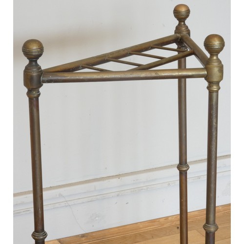 237 - An Edwardian brass corner umbrella stand, with four divisions on a cast iron base with inset drip tr... 