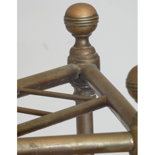 237 - An Edwardian brass corner umbrella stand, with four divisions on a cast iron base with inset drip tr... 