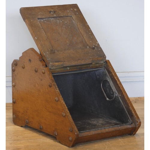 238 - An Edwardian oak coal scuttle, the panelled fall-front with brass handles and mounts, complete metal... 