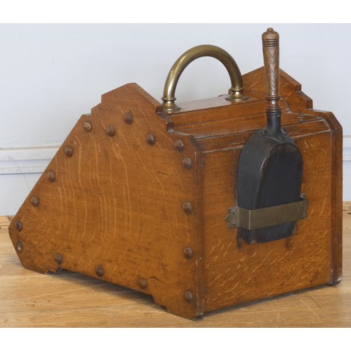 238 - An Edwardian oak coal scuttle, the panelled fall-front with brass handles and mounts, complete metal... 