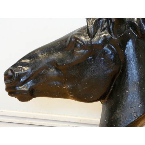 242 - A pair of metal horses heads, painted black, 62 x 58cm