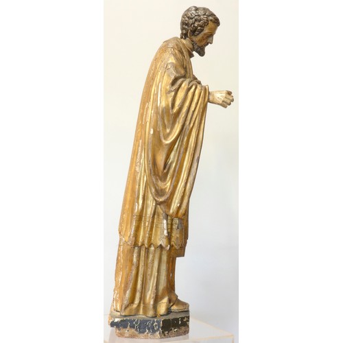 244 - A continental sculpted and gilt painted limewood model of a saint, in the 16th century style, 101cm.