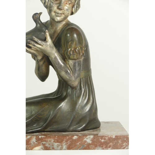 245 - An early 20th century spelter figure of a seated girl with a dove, raised on a marble base, 30 x 12 ... 