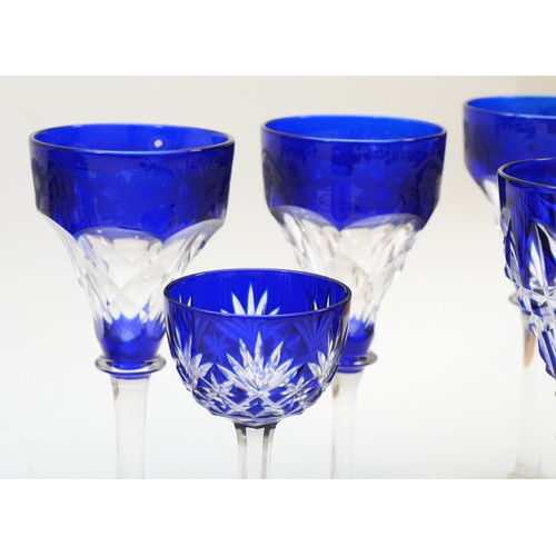 255 - A 20th century Bohemian blue glass decanter, together with a set of four matching sherry glasses and... 