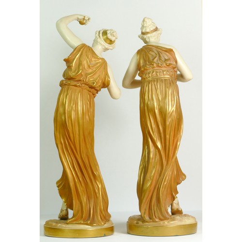 266 - A pair of Royal Worcester gilt and blush ivory figures of Classical Maidens, modelled by James Hadle... 