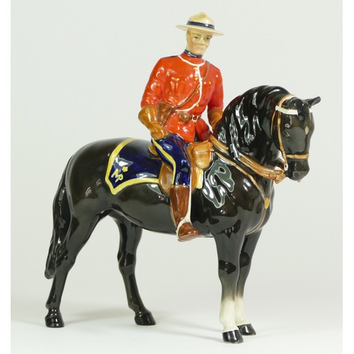 312 - A Beswick model of a policeman on a horse, H21cm, together with two Beswick Shetland ponies. (3)