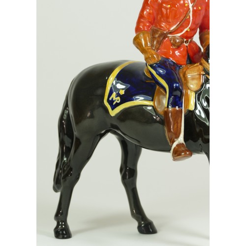 312 - A Beswick model of a policeman on a horse, H21cm, together with two Beswick Shetland ponies. (3)