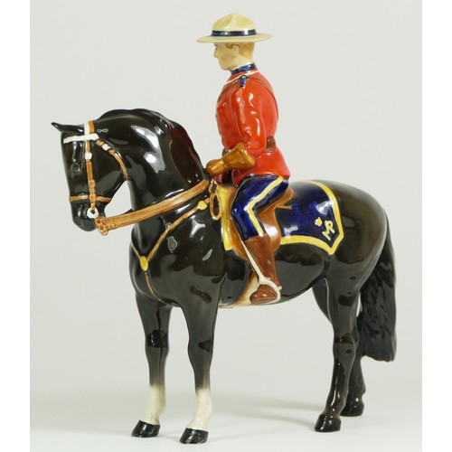 312 - A Beswick model of a policeman on a horse, H21cm, together with two Beswick Shetland ponies. (3)