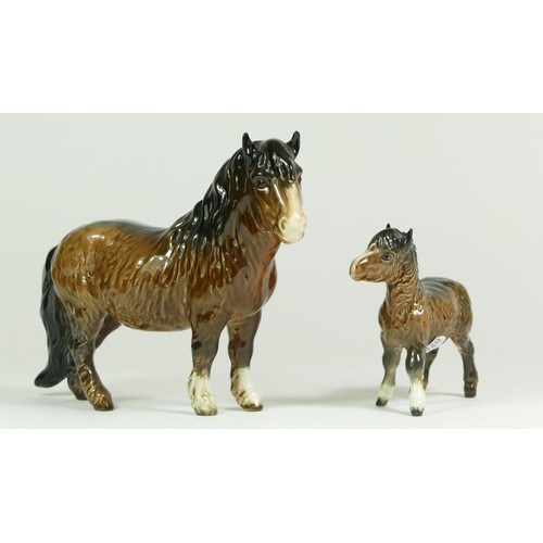 312 - A Beswick model of a policeman on a horse, H21cm, together with two Beswick Shetland ponies. (3)