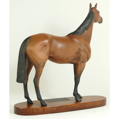 313 - A Beswick figurine, modelled as a chestnut horse, Red Rum, raised upon an oval base with plaque deta... 