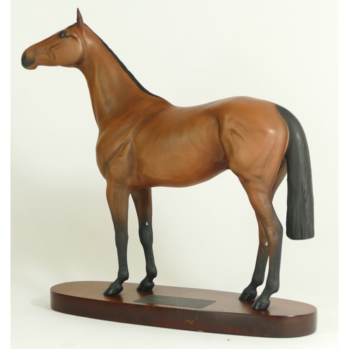 313 - A Beswick figurine, modelled as a chestnut horse, Red Rum, raised upon an oval base with plaque deta... 