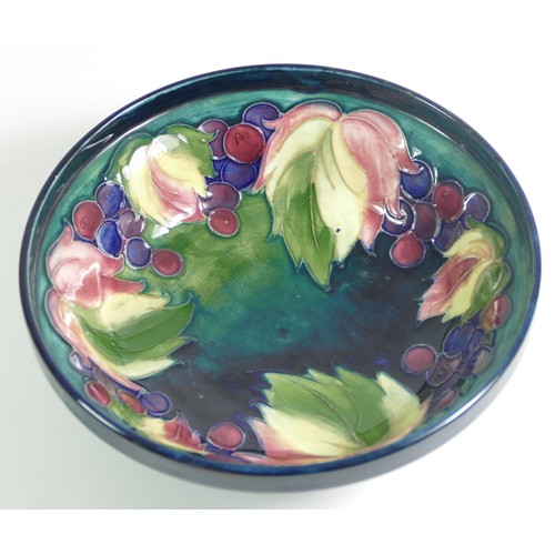 285 - A Moorcroft dish raised on a pedestal, leaf and berry pattern, singed W. Moorcroft on the base, 16.5... 