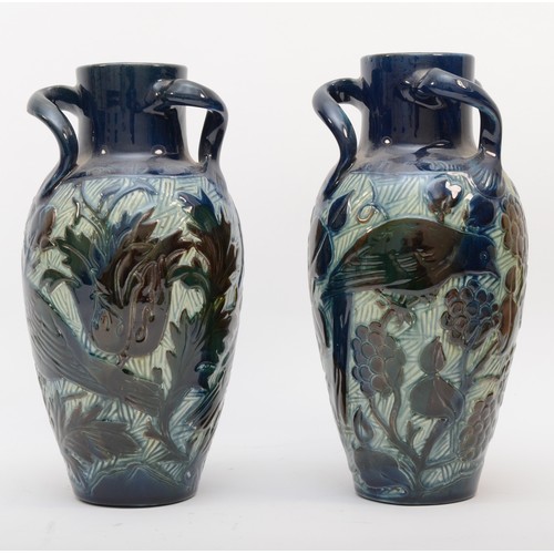 290 - A pair of Lauder Barum Art Pottery glazed vases, having three angular handles, decorated with birds ... 