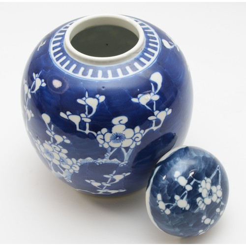 325 - A Chinese lidded ginger jar, hand decorated in blue & white with prunus foliage, circa late 19th cen... 