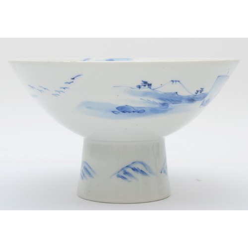 321 - A Japanese blue and white porcelain stem cup, early 20th century, painted in overglaze enamels to sh... 