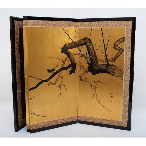 323 - A Japanese byobu gold paper folding screen divider, four panels with ebonised frame depicting birds ... 