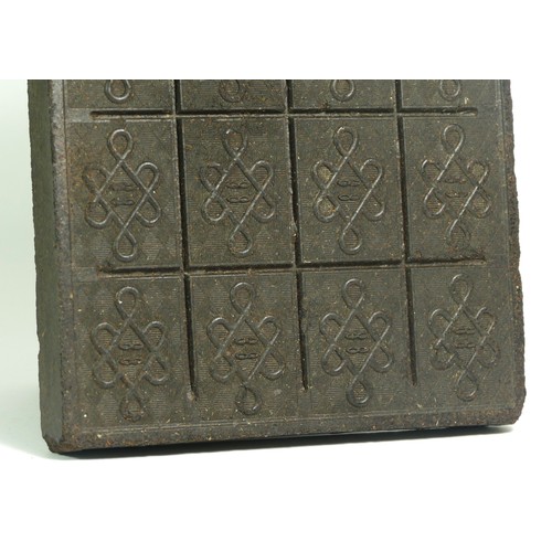 334 - A Chinese tea brick, early 20th century,  23.5 x 18.5cm, this compressed 'cake' of tea was often use... 