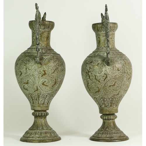 341 - An Indian pair of brass two handled vases, with all over animal and hunter decoration, 32.5cm