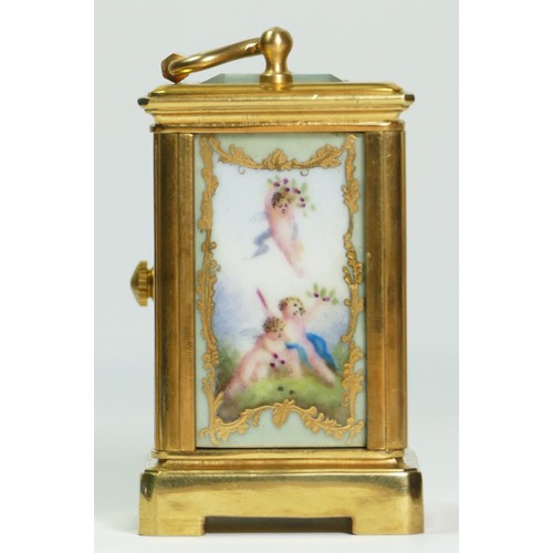 354 - A brass and porcelain panel small carriage timepiece, decorated with cherubs, 6.5cm