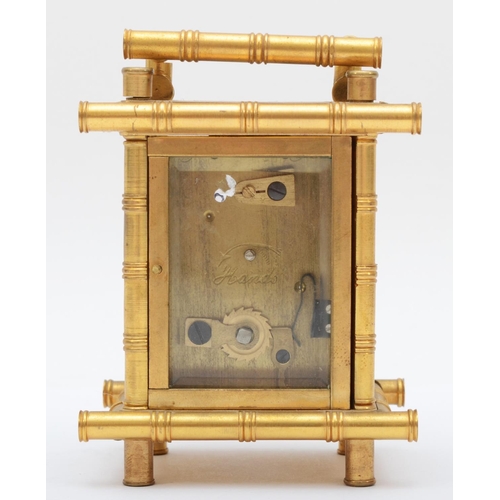 357 - A brass carriage clock, retailed by Elliott & Son London, with stylised bamboo gilt frame, housing a... 