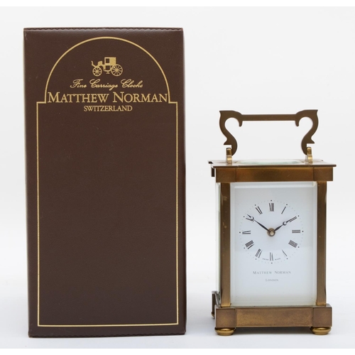 358 - A Matthew Norman of London brass carriage clock, having Swiss eight day movement, boxed with key and... 