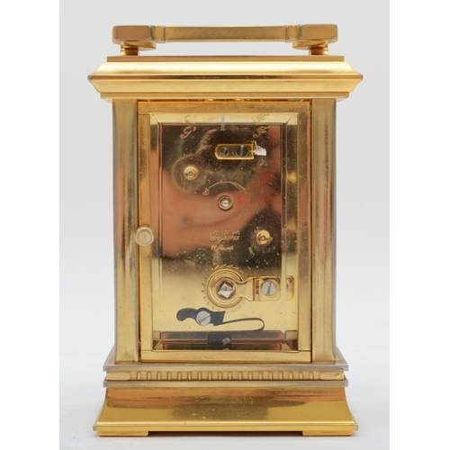 360 - An English brass carriage clock, the enamelled dial with Roman numerals, having eight day jewelled m... 