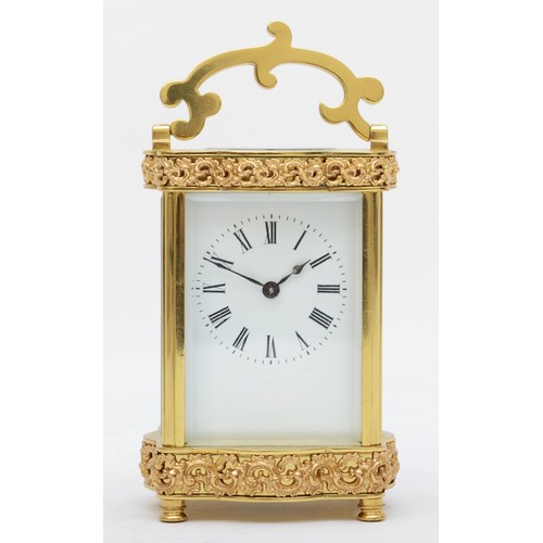 366 - A mid 20th century brass carriage clock, having enamelled dial with Roman numerals, with platform es... 