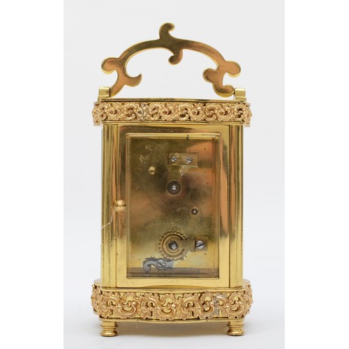 366 - A mid 20th century brass carriage clock, having enamelled dial with Roman numerals, with platform es... 