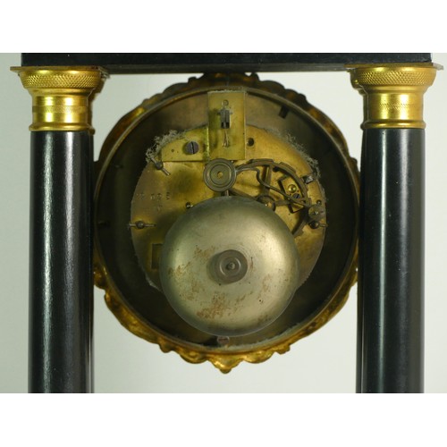 378 - A French Empire style ebony four pillar mantel clock, with eight day drum movement, striking on a si... 