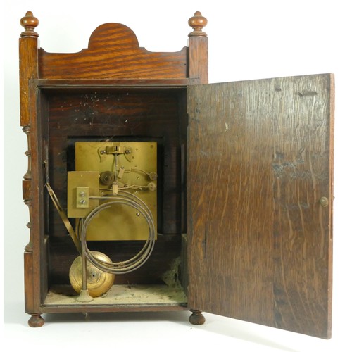 386 - An Edwardian oak bracket clock, the case with open fretwork gallery, turned columns and finials with... 