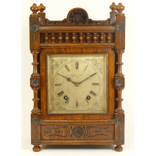 386 - An Edwardian oak bracket clock, the case with open fretwork gallery, turned columns and finials with... 