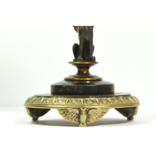 393 - A late 19th century brass aneroid barometer, raised on a bronzed patinated sphinx, to a brass stand ... 